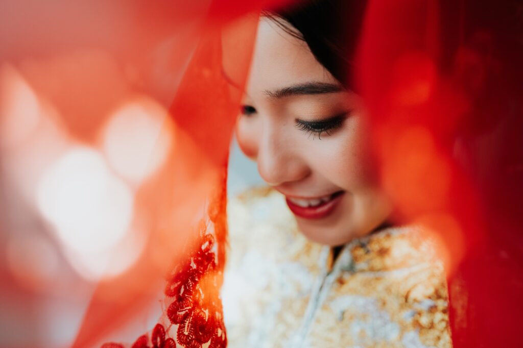 Bride in a red veil and kua on her Chinese wedding day in Kuala Lumpur