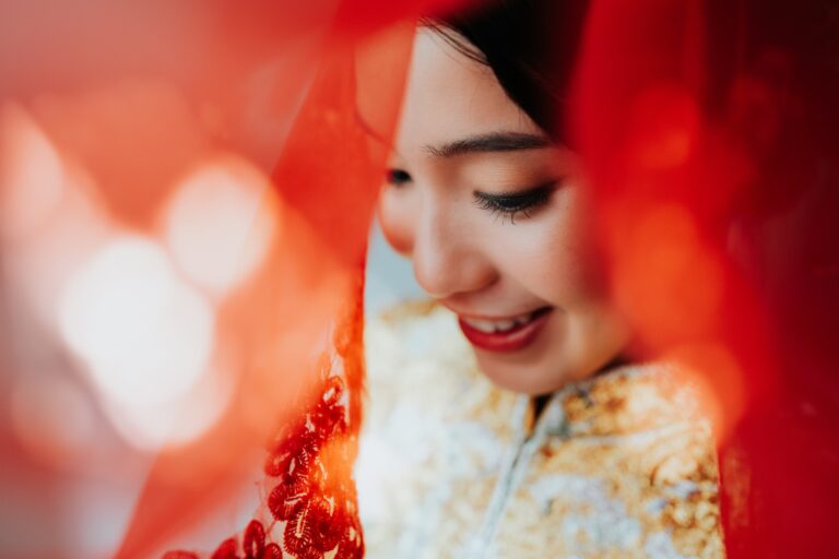 Bride in a red veil and kua on her Chinese wedding day in Kuala Lumpur