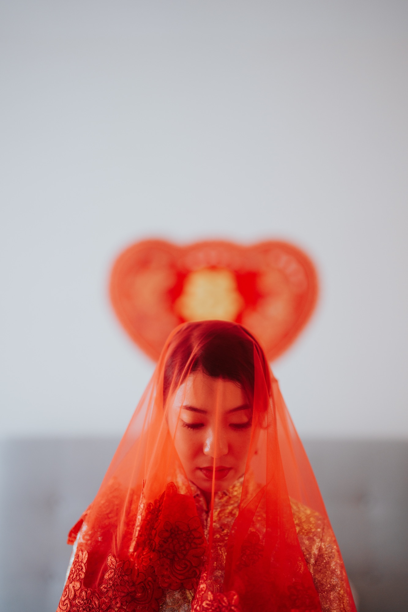 Bride in a red veil waiting to be fetched at a Chinese wedding in Kuala Lumpur