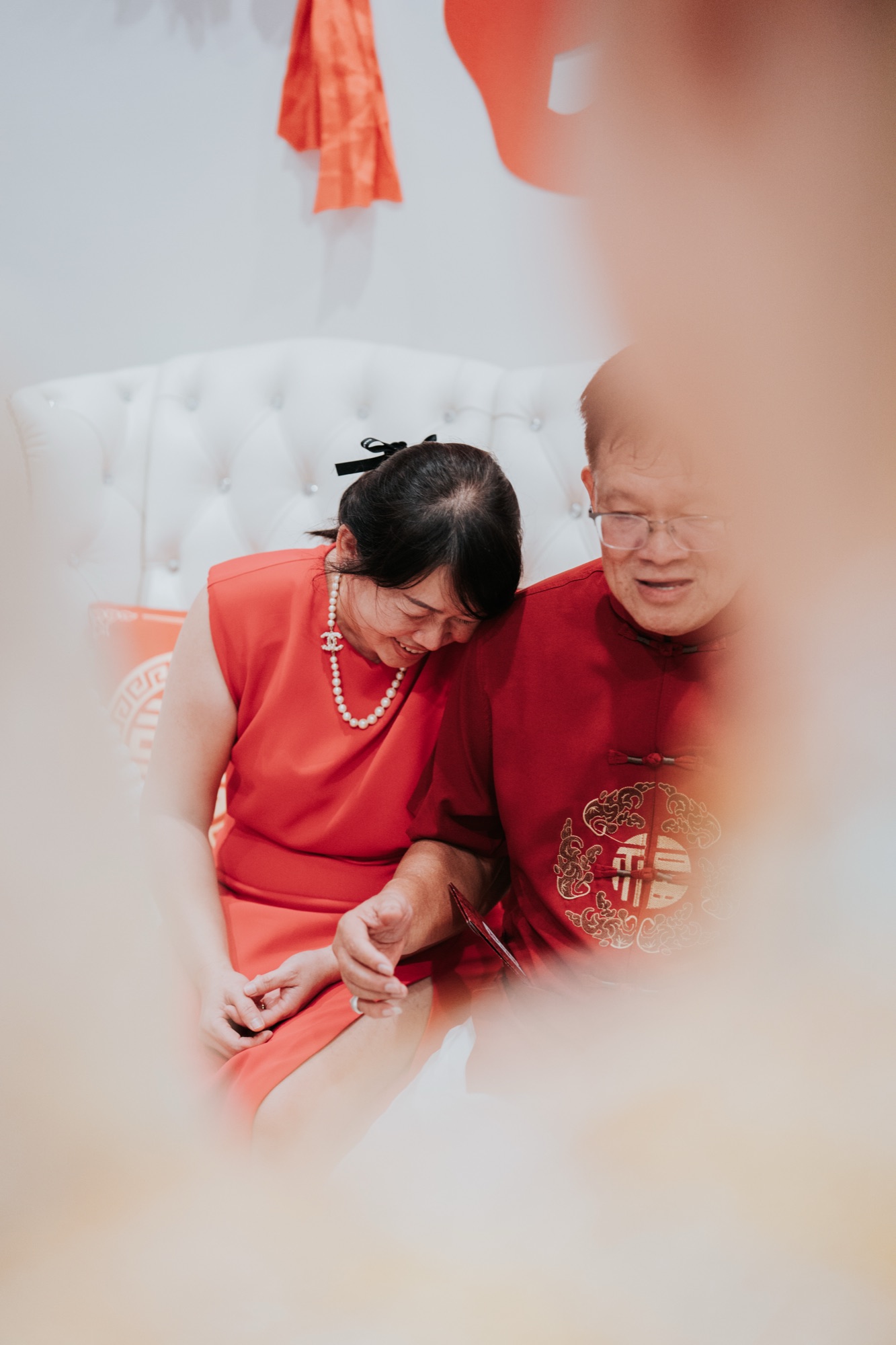 Parents laughing together at a Chinese wedding in Kuala Lumpur