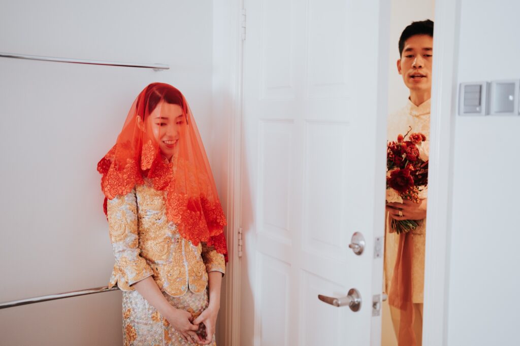 Groom peeking around the door to fetch the bride at a Chinese wedding in Kuala Lumpur