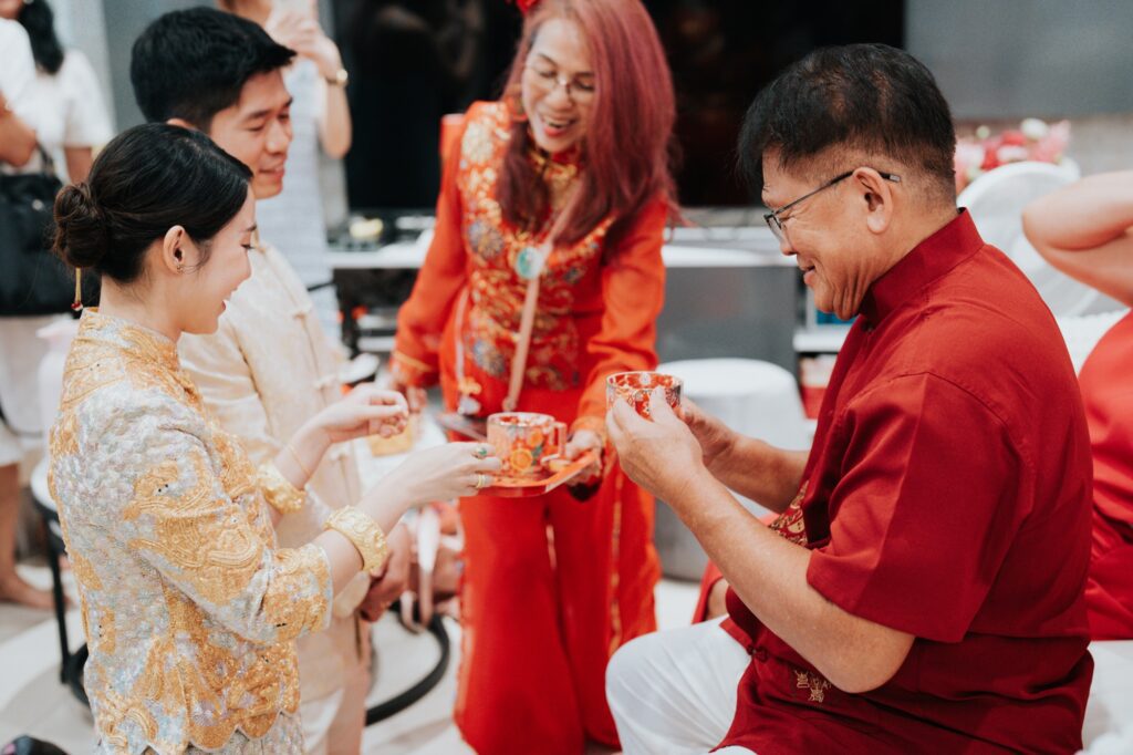 Bride serving tea to the elders at a Chinese tea ceremony in Kuala Lumpur