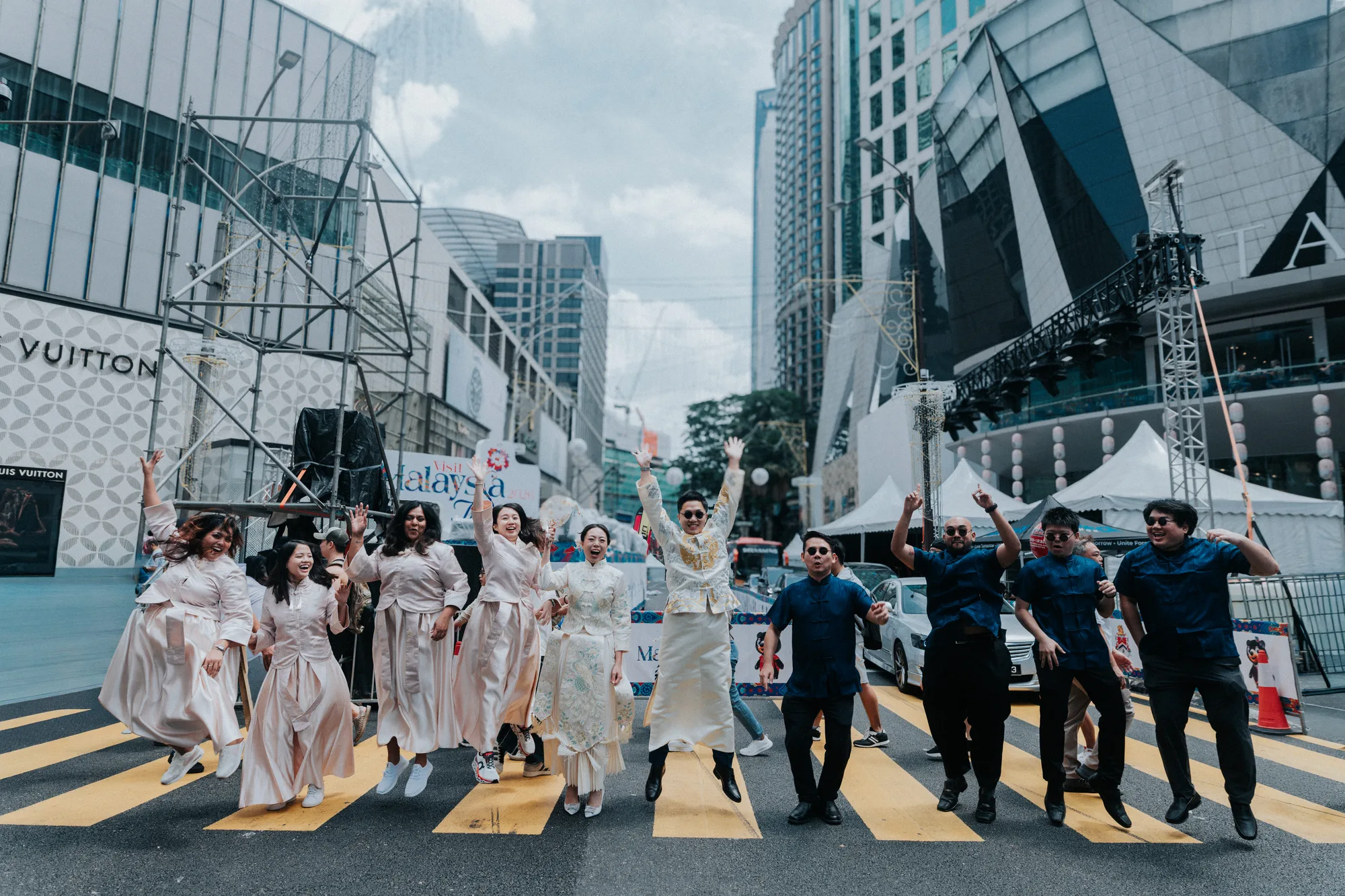 The whole wedding party leaping on the zebra crossing in Bukit Bintang