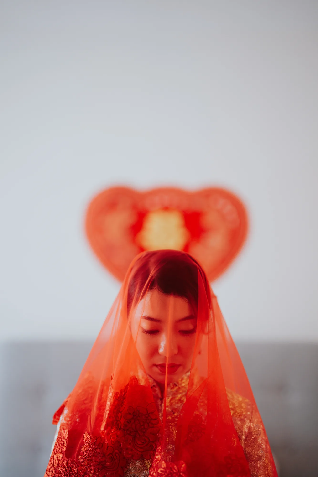 Jocelyn under her red veil on the morning of her wedding